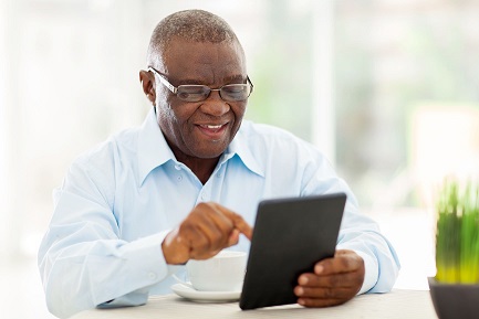 Stock image of smiling patient with iPad