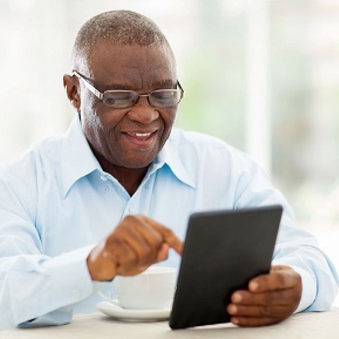 Stock image of smiling patient with iPad